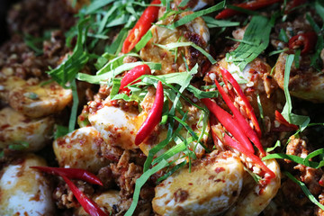 Boiled egg spicy salad topping by chilli and Kaffir lime leaves
