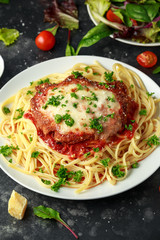 Chicken Parmesan with Cheese and Marinara Sauce served over spaghetti, pasta