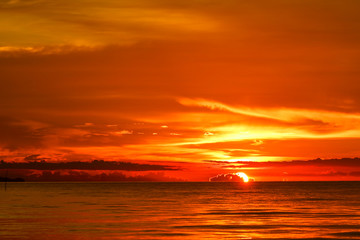 Fototapeta na wymiar sunset on sea and ocean last light red sky silhouette cloud