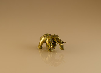 Souvenir - a bronze elephant on the mirror surface. Vintage item. Gift of travel