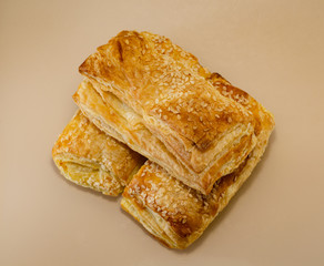 Three sesame buns, taken from the top, on a glass surface. Puff pastry. Baked Dessert