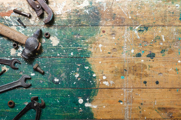 Flat lay set of vintage carpentry tools on colorful wooden background. Top view workbench with...