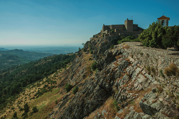 Fototapeta na wymiar Stone wall and tower of Castle and mountainous landscape