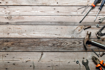 Flat lay composition with vintage carpentry tools on rough wooden background. Top view workbench with carpenter different tools. Woodworking, craftsmanship and handwork concept. 
