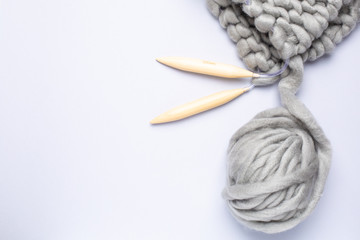 Knitting project in progress. A piece of knitting with ball of yarn and a knitting needles.