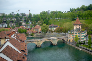 Fototapeta na wymiar Beautiful view of Nydegg bridge on aare river with charming building and fresh green trees in downtown of Bern, Switzerland