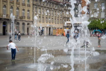 Close up of splash water from fountain at public plaza in downtown of bern