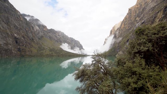 Woman at blue lake in Peru Cordillera Blanca arms lake 69 snow mountains scenary
