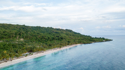 Aerial view of the beach and hills with nice sky and blue ocean in Wakatobi, Indonesia, Asia