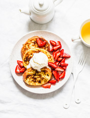 French toast with ice cream and strawberries on a light background, top view. Delicious breakfast, dessert, snack.Flat lay