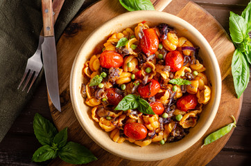 Corn paste with roasted tomatoes and fresh peas and onion