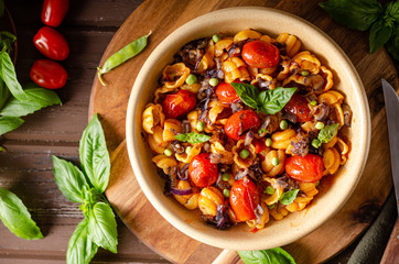 Corn paste with roasted tomatoes and fresh peas and onion