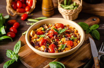 Corn paste with roasted tomatoes and fresh peas and onion