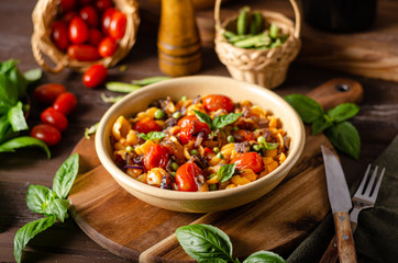 Corn paste with roasted tomatoes and fresh peas and onion