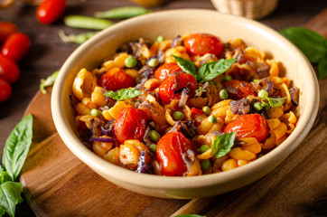 Corn paste with roasted tomatoes and fresh peas and onion
