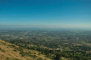 Obraz premium Landscape covered by wooden hills and cultivated fields