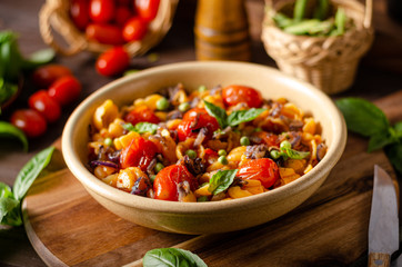Corn paste with roasted tomatoes and fresh peas and onion