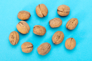 A lot of walnuts on a blue background. Food for the brain. Healthy food