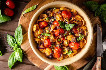 Corn paste with roasted tomatoes and fresh peas and onion