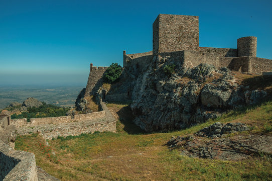 Walls and towers over rocky hill with garden at the Marvao Castle