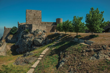 Fototapeta na wymiar Walls and towers over rocky hill with garden at the Marvao Castle