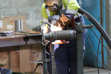 industrial worker welding in factory