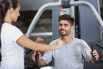tanned man training on exercise machine