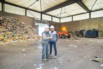 full length view of two men in recycling center