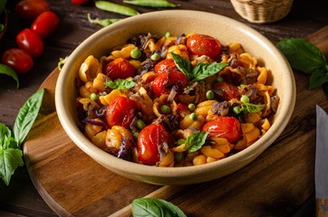 Corn paste with roasted tomatoes and fresh peas and onion