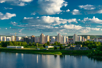 city view of houses and river and clouds