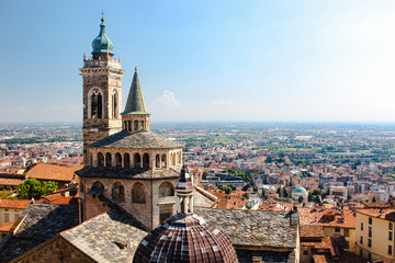 Fototapeta na wymiar View of a church and Bergamo, Italy from the top of a tower on a hill.