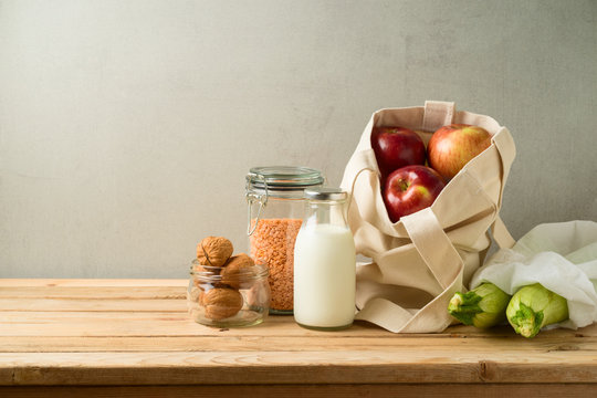 Zero waste lifestyle and shopping concept with cotton bag and glass jars on wooden table