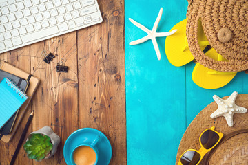 Summer holiday vacation concept with beach accessories and office desk background. Top view from above