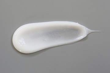 Cosmetic cream lotion isolated on gray background.