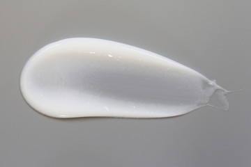 Cosmetic cream lotion isolated on gray background.