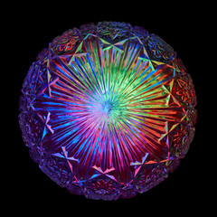 Multicolored rays of light shine through a crystal ball with an outstanding pattern