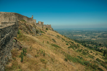 Fototapeta na wymiar Walls and watchtowers over rocky ridge at the Marvao Castle