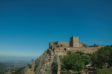 Stone walls and tower of Castle over hill near garden at Marvao