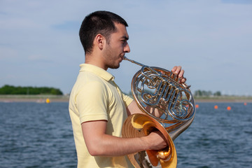 French horn instrument. Player hands playing horn music brass instrument
