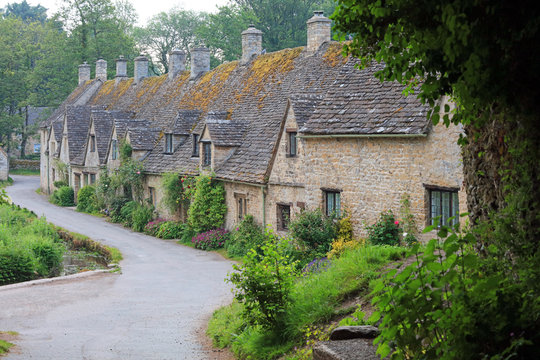 Row Of Old English Stone Cottages Set In The Cotswold Village Of Bibury