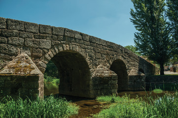 Fototapeta na wymiar Old Roman stone bridge over the Sever River in Portagem