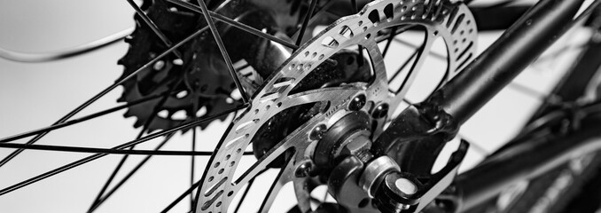 Fototapeta close-up shot of named mechanic brake disc on bicycle in black and white obraz