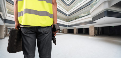 Construction Worker in front of construction site