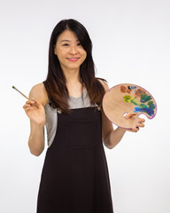 Artist holding painting palette and brush