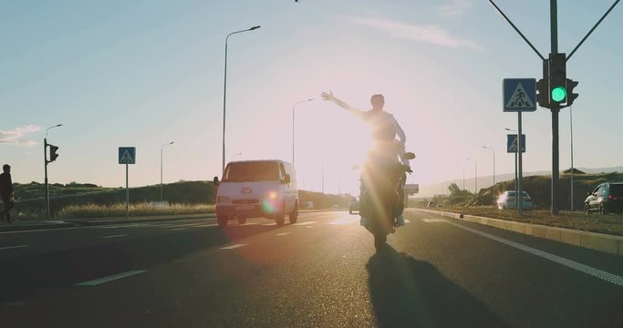 couple in love riding a motorcycle during sunset