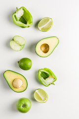 Green vegetables and fruits on white background