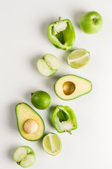 Green vegetables and fruits on white background