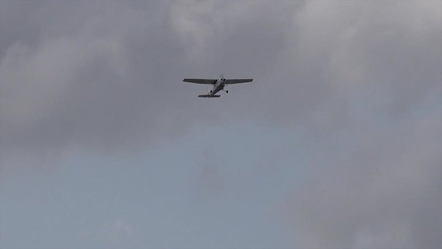 A light motor plane taking off from an airfield in Addison Texas on a summer evening.
