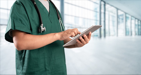 young doctor with hospital background