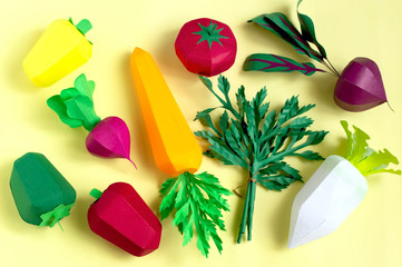 Set of paper vegetables on yellow background